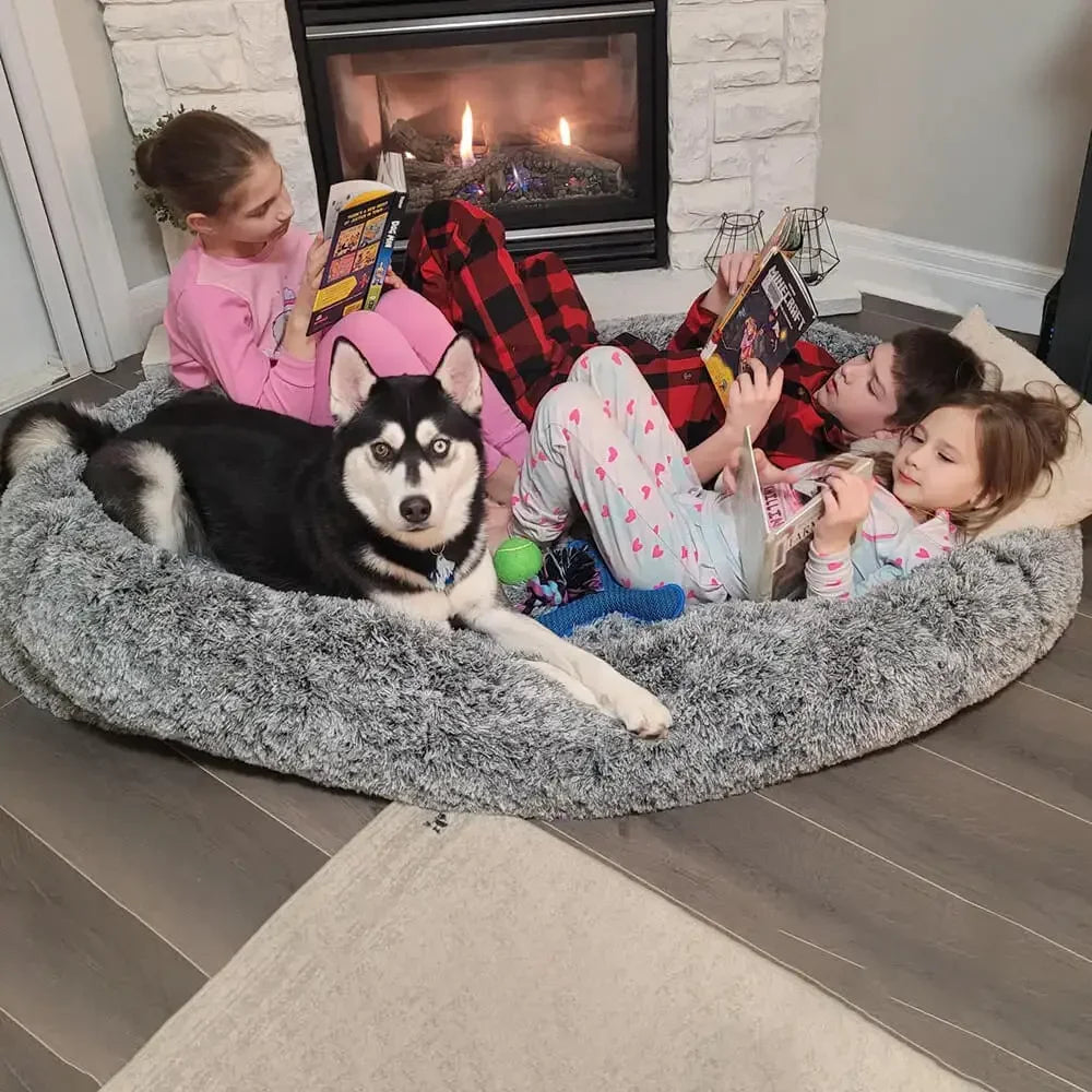 Super Large Plush Dog Sofa Bed in gray color with waterproof, washable cover and raised sides, perfect for large dogs lounging comfortably.

